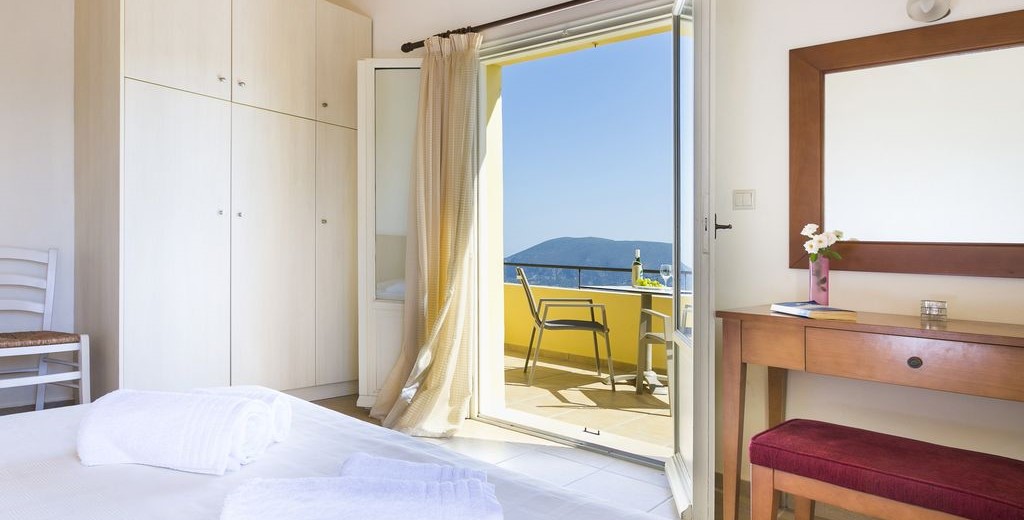 Bedroom with its own balcony and plenty of storage for you possessions during your holiday to Villa Cypress, Fiscardo, Kefalonia, Greek Islands