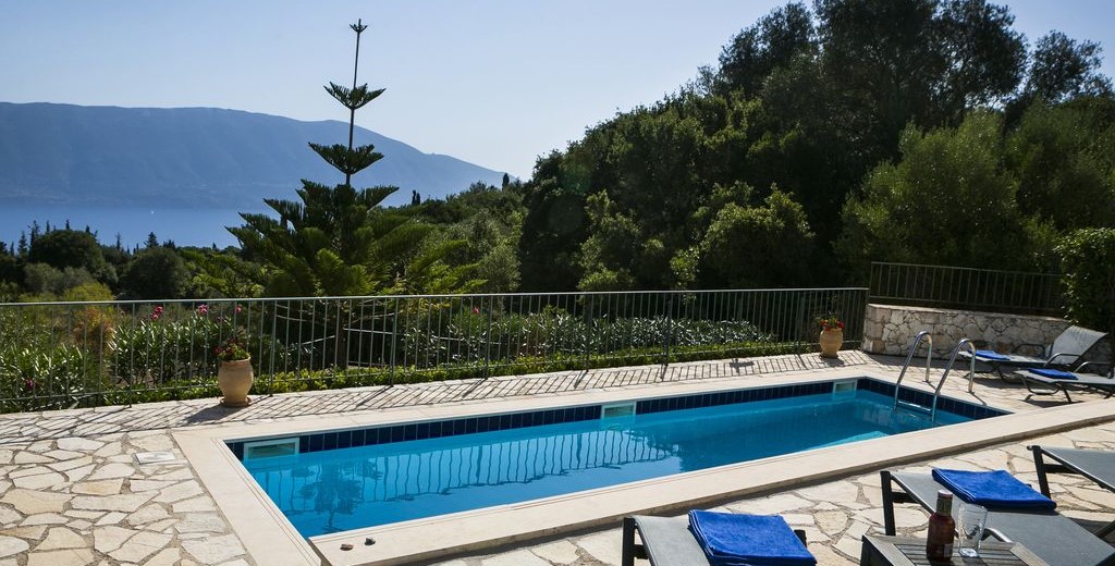 Sun beds on the terrace with pool surrounded by tree's and natural Kefalonia, Villa Cypress, Fiscardo, Kefalonia, Greek Islands