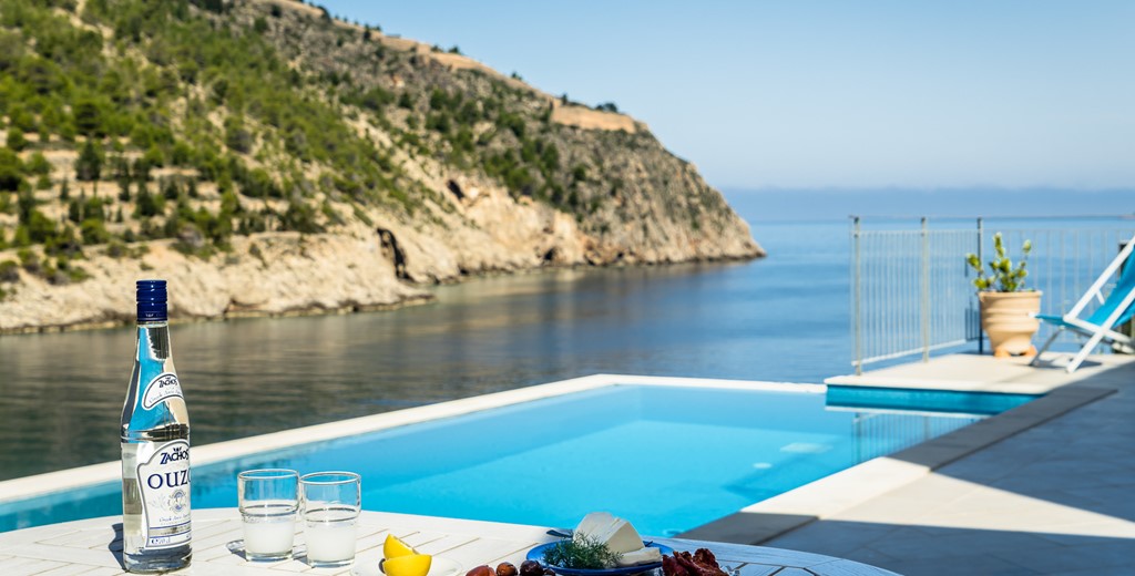 Afternoon drinks outside on the edge of the infinity pool at Villa Plori, Assos, Kefalonia