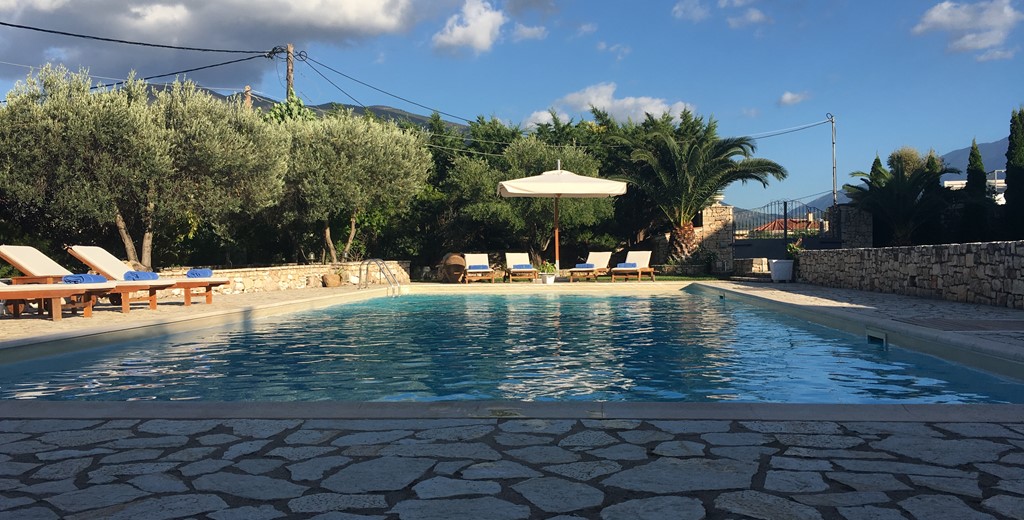 Evening sun around the pool at Casa Angela, Melissani Apartments, Karavomilos, Kefalonia, Greek Islands