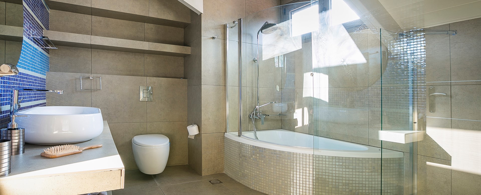 Corner bath with shower over and separate shower inside Marina Penthouse Apartment, Argostoli, Kefalonia, Greek Islands
