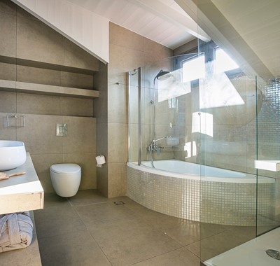 Corner bath with shower over and separate shower inside Marina Penthouse Apartment, Argostoli, Kefalonia, Greek Islands