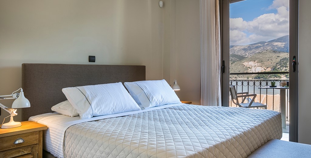 Bedroom with large double bed and access to the balcony with views across Argostoli, Kefalonia, Greek Islands