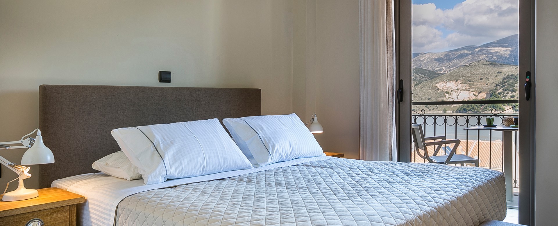 Bedroom with large double bed and access to the balcony with views across Argostoli, Kefalonia, Greek Islands